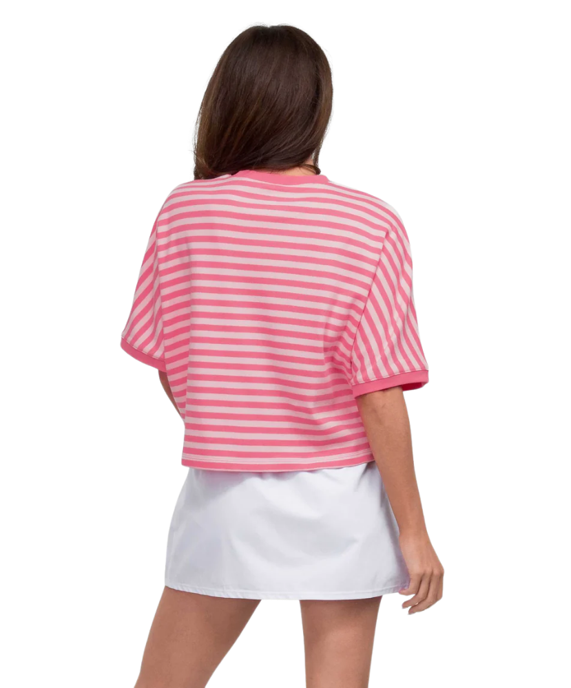 Woman wearing a pink and white striped shirt and white skirt on a white background