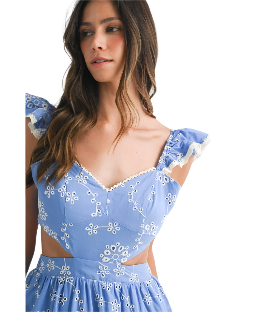 Woman wearing a blue floral dress with a plain background