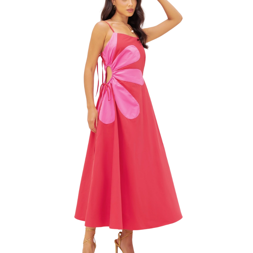 Woman wearing a pink dress with a floral design on a white background