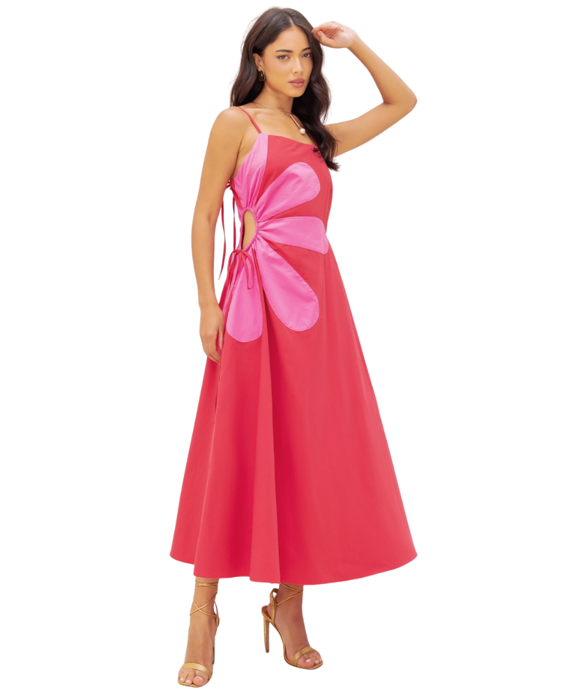 Woman wearing a pink dress with a floral design on a white background