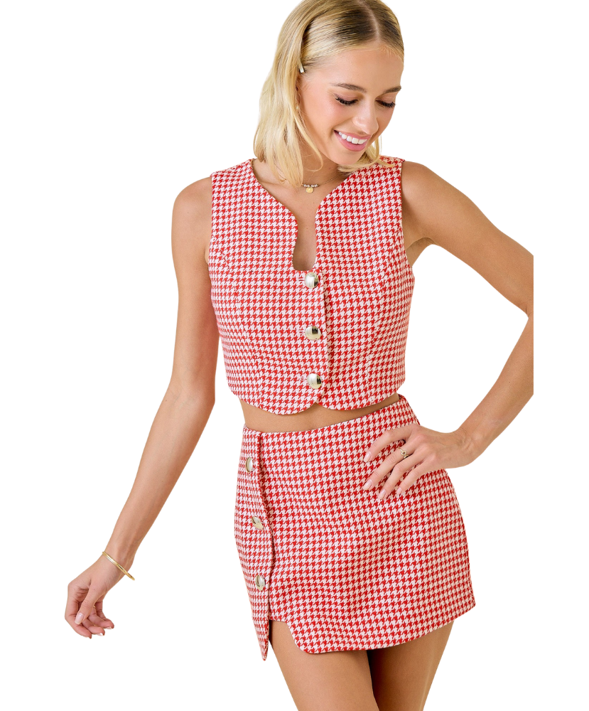 Woman wearing a red and white checkered dress on a white background