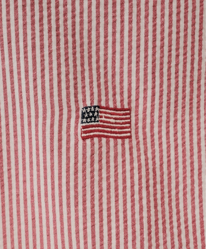 Red and white striped fabric with an embroidered American flag patch.