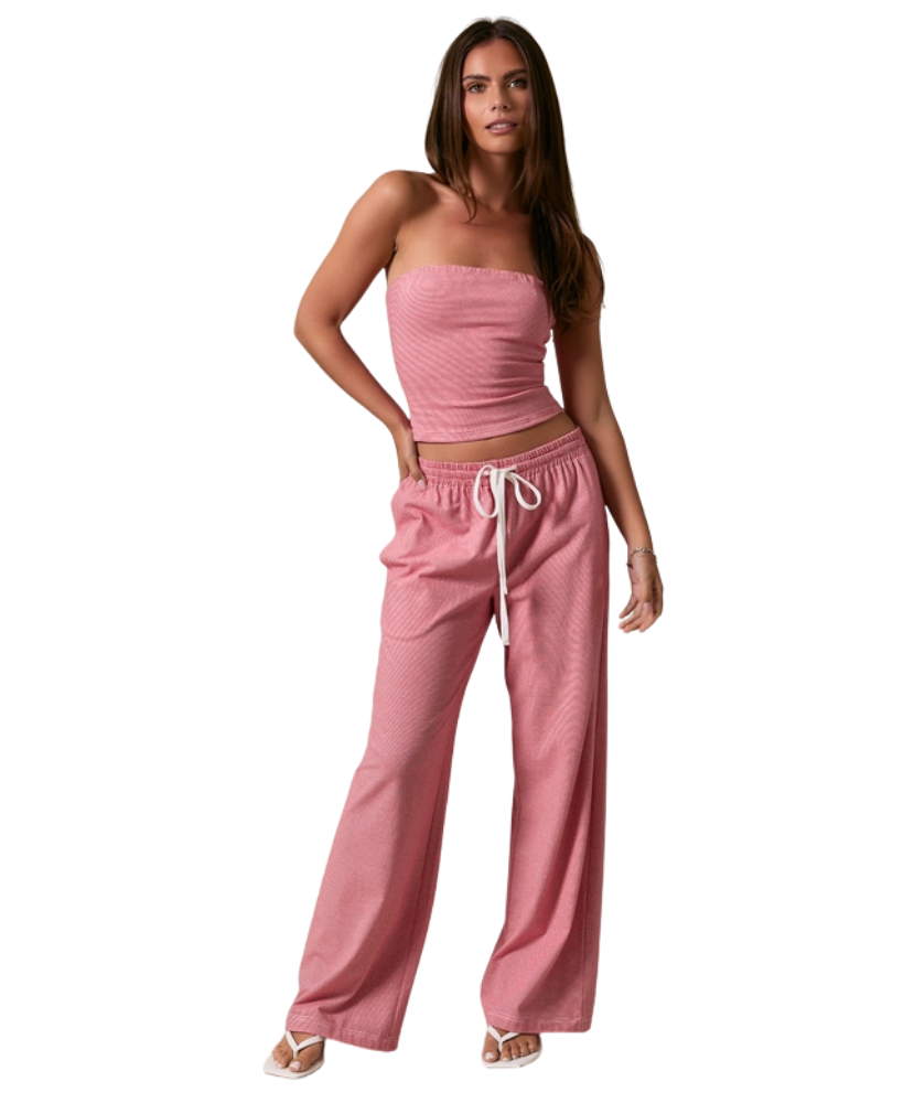 Woman wearing a RED AND WHITE STRIPED strapless top and pants on a white background