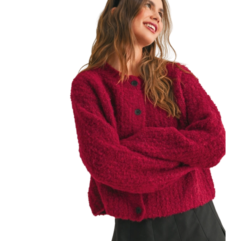 Woman wearing a red cardigan on a white background
