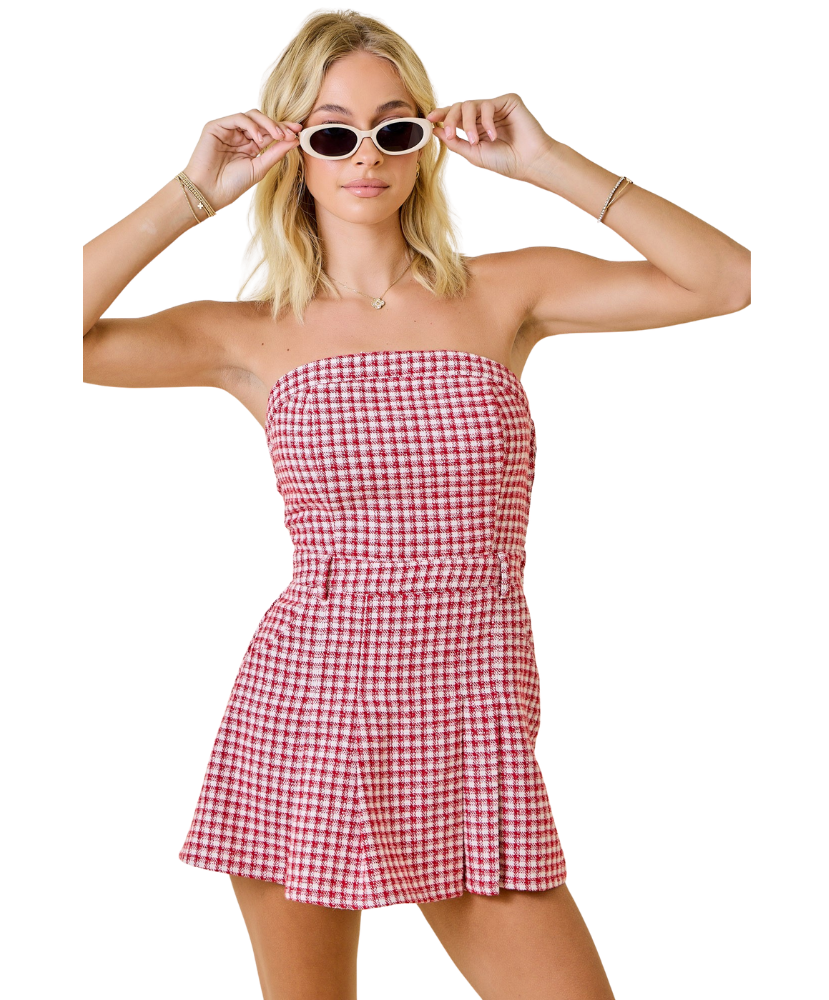 Woman wearing a red and white checkered dress on a white background