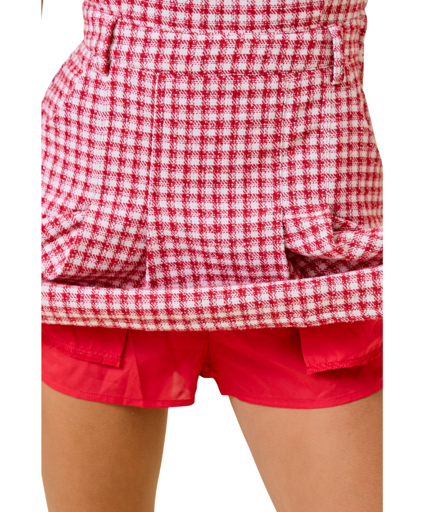 Red and white checkered shirt over red shorts on a white background