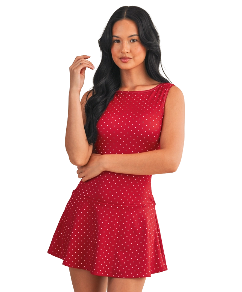 Woman wearing a red polka dot dress on a white background