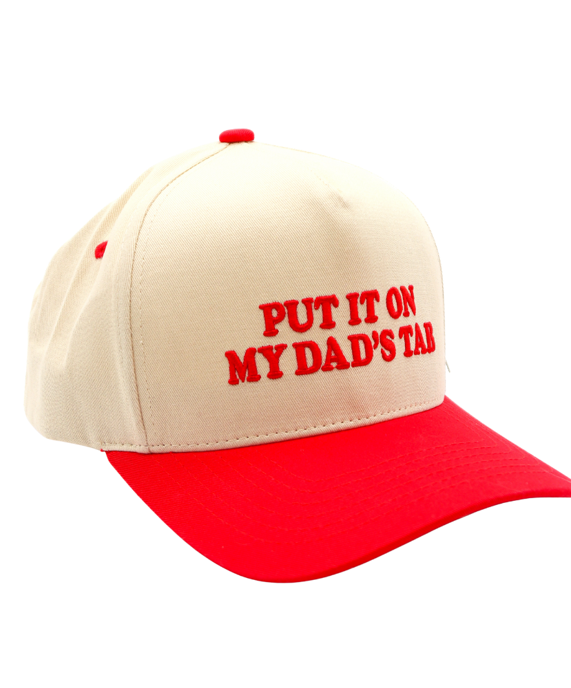 Beige and red cap with text 'PUT IT ON MY DAD'S TAB' on a white background