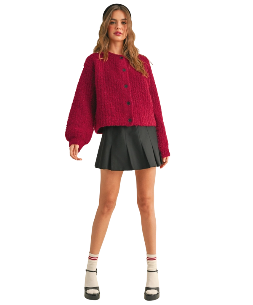 Woman wearing a red cardigan on a white background