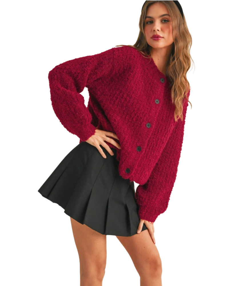 Woman wearing a red cardigan on a white background