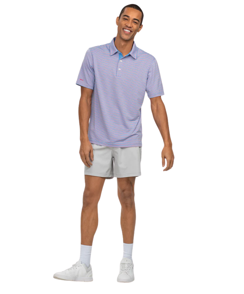 Man wearing a Southern Shirt Co light purple striped polo shirt and gray shorts on a white background