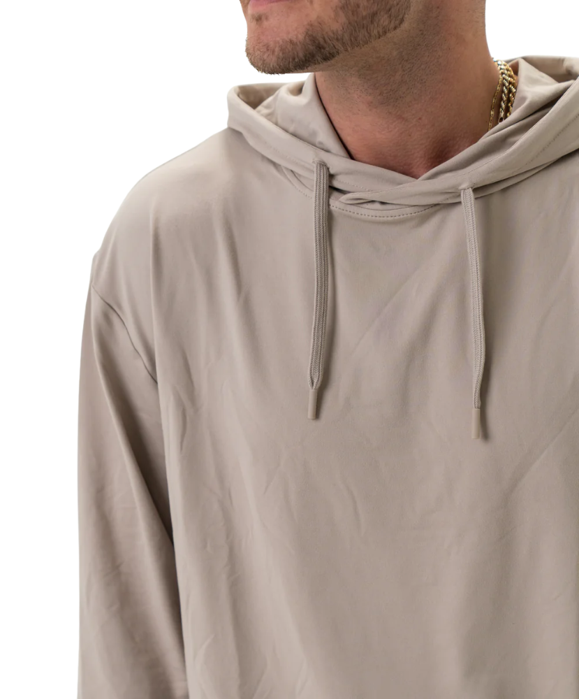 Beige hoodie worn by a person on a white background