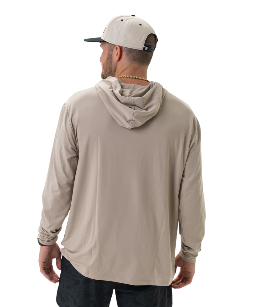Man wearing a beige long-sleeve hoodie and cap on a white background