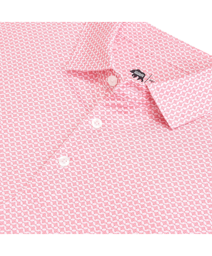 Close-up of a pink patterned shirt with a brand logo on a white background