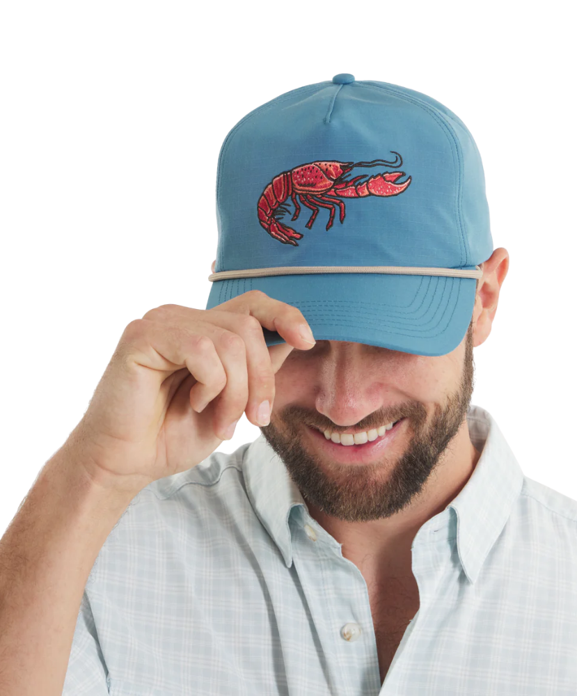 Man wearing a blue cap with a red CRAWFISH design on a white background