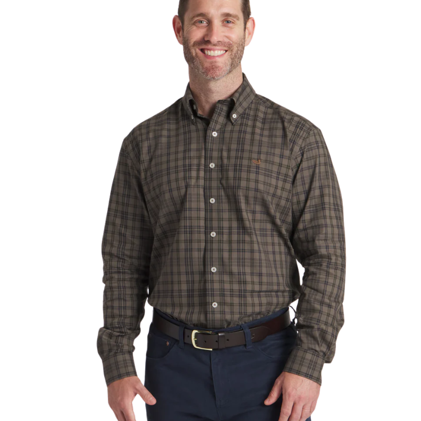 Man wearing a Southern Marsh plaid shirt and dark pants on a white background