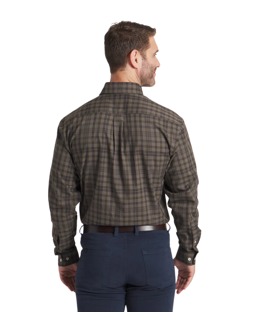 Man wearing a Southern Marsh plaid shirt and dark pants on a white background
