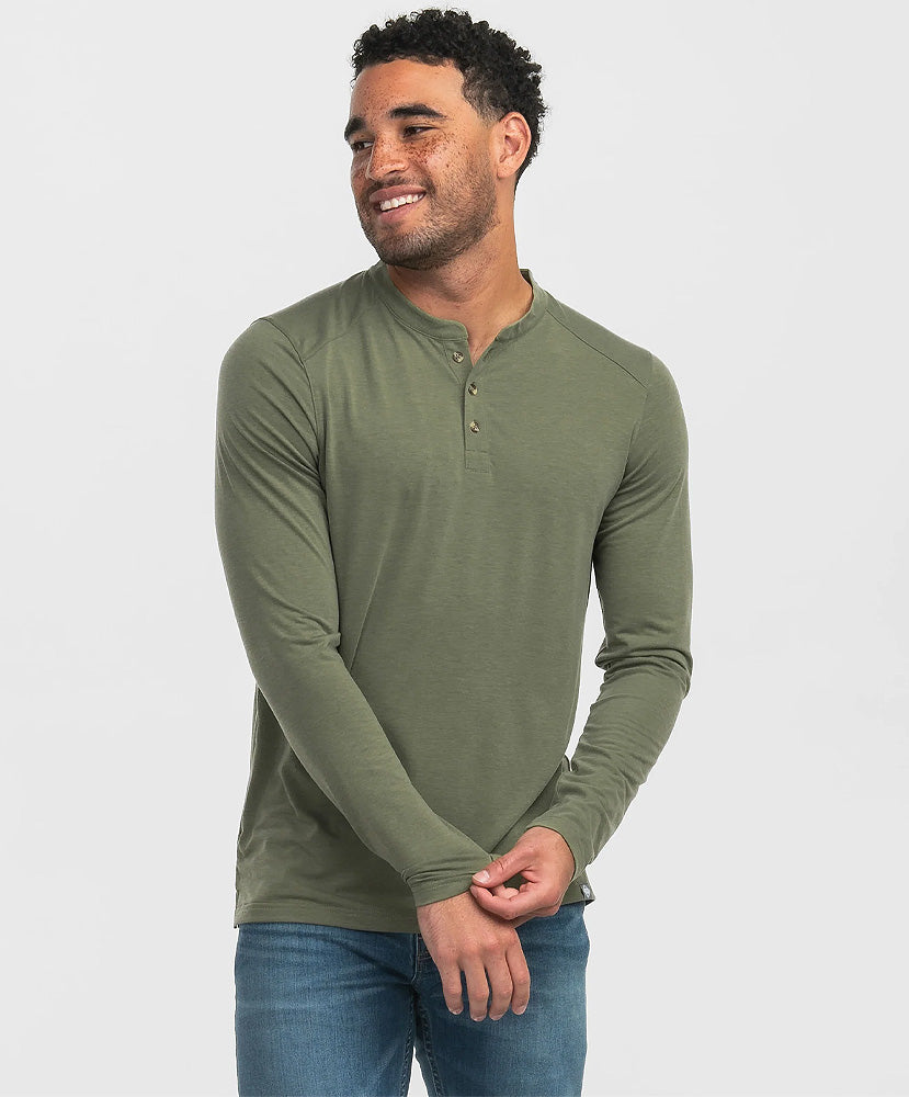 A man wearing a green long-sleeve henley shirt with a 2-button closure