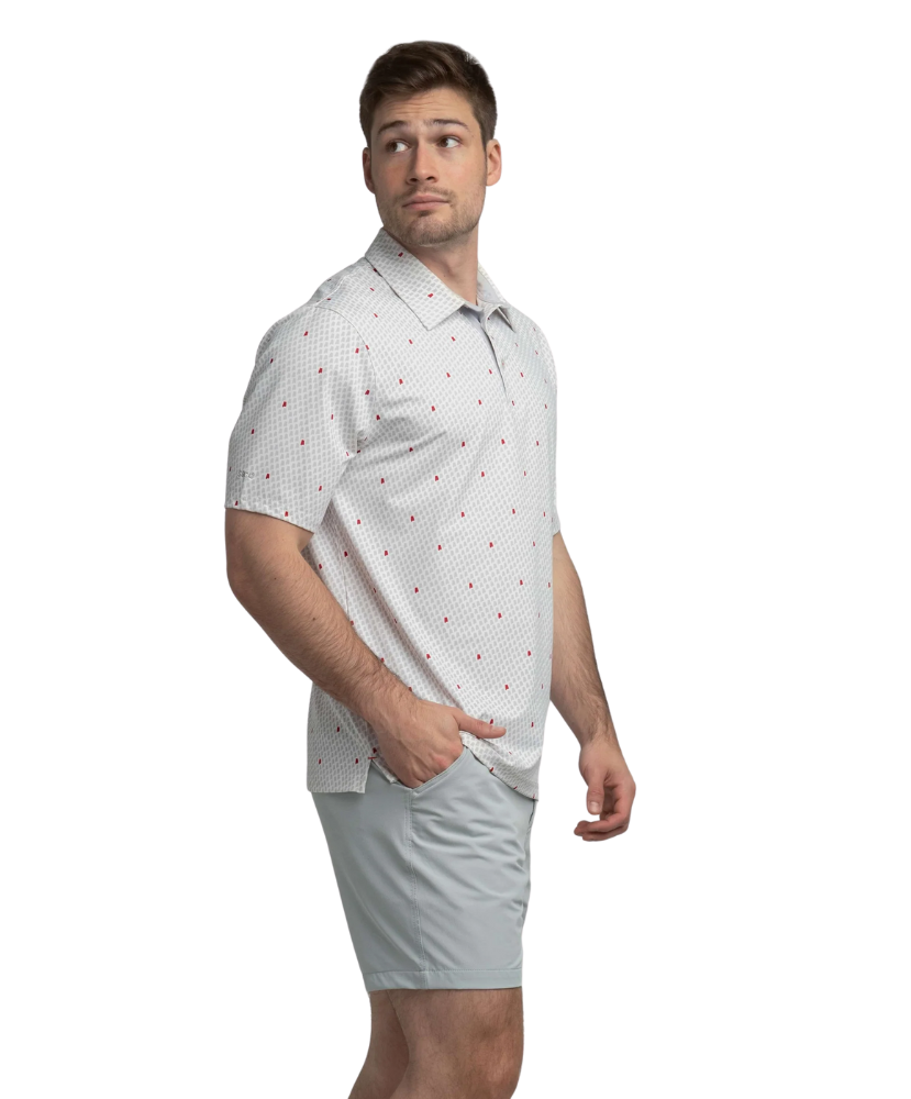 Man wearing a white polo shirt with red Alabama state outline pattern and 'SSCO' logo on a white background and light shorts on a white background