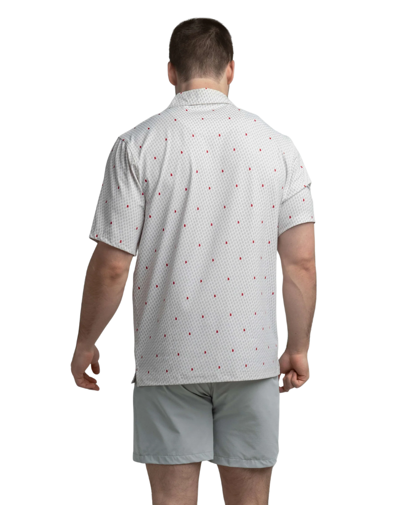 Man wearing a white polo shirt with red Alabama state outline pattern and 'SSCO' logo on a white background and light shorts on a white background