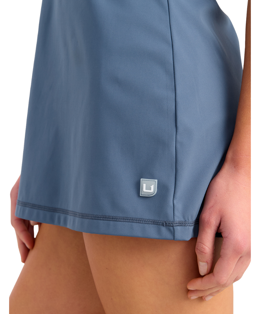 Blue dress with a HUK logo on a white background