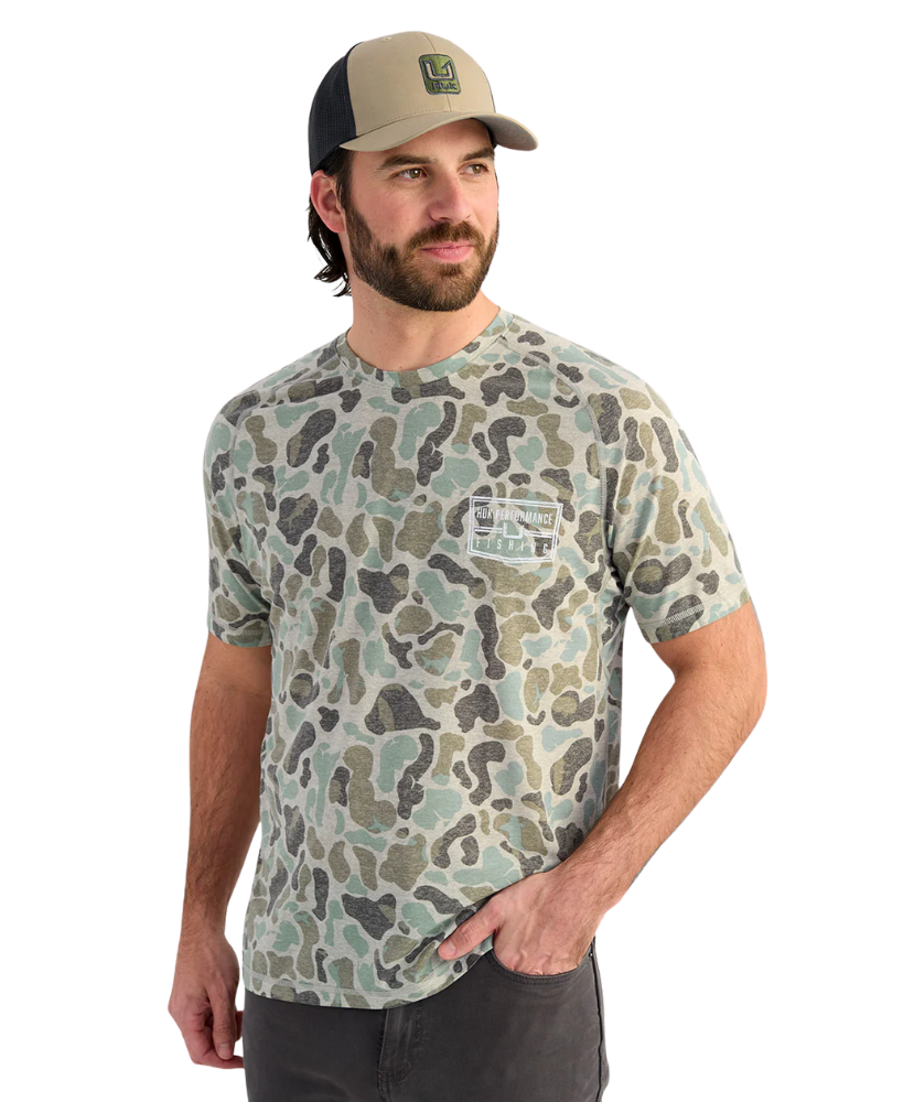 Man wearing a camouflage t-shirt and cap on a white background