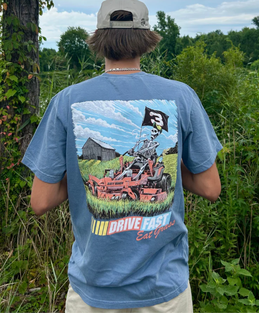 Person wearing a blue t-shirt with a graphic design outdoors