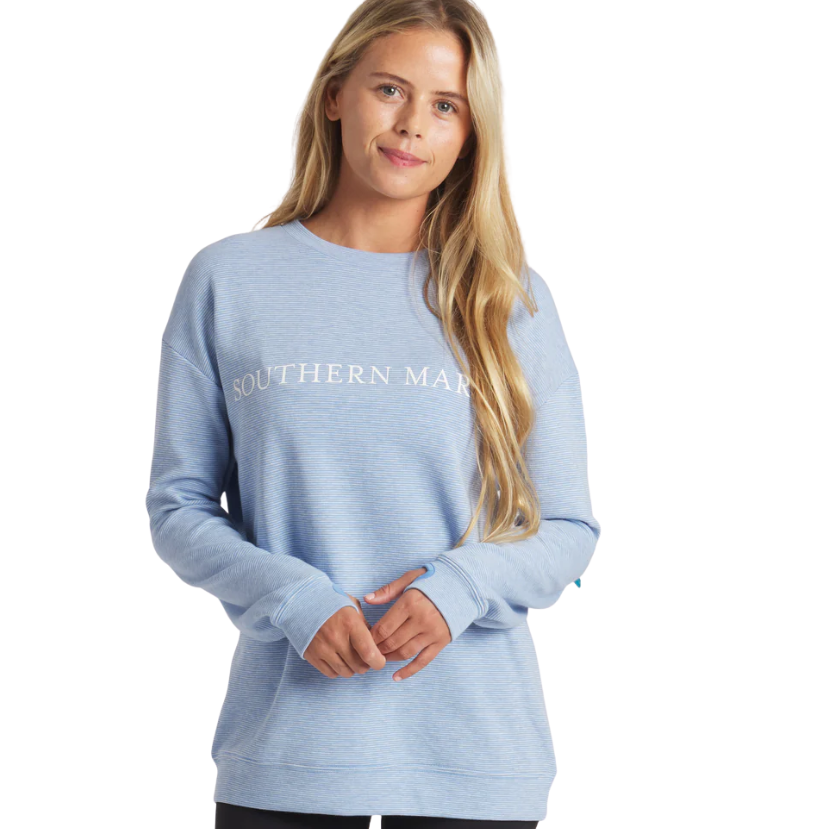 Woman wearing a light blue sweatshirt with 'Southern Marsh' text on a white background