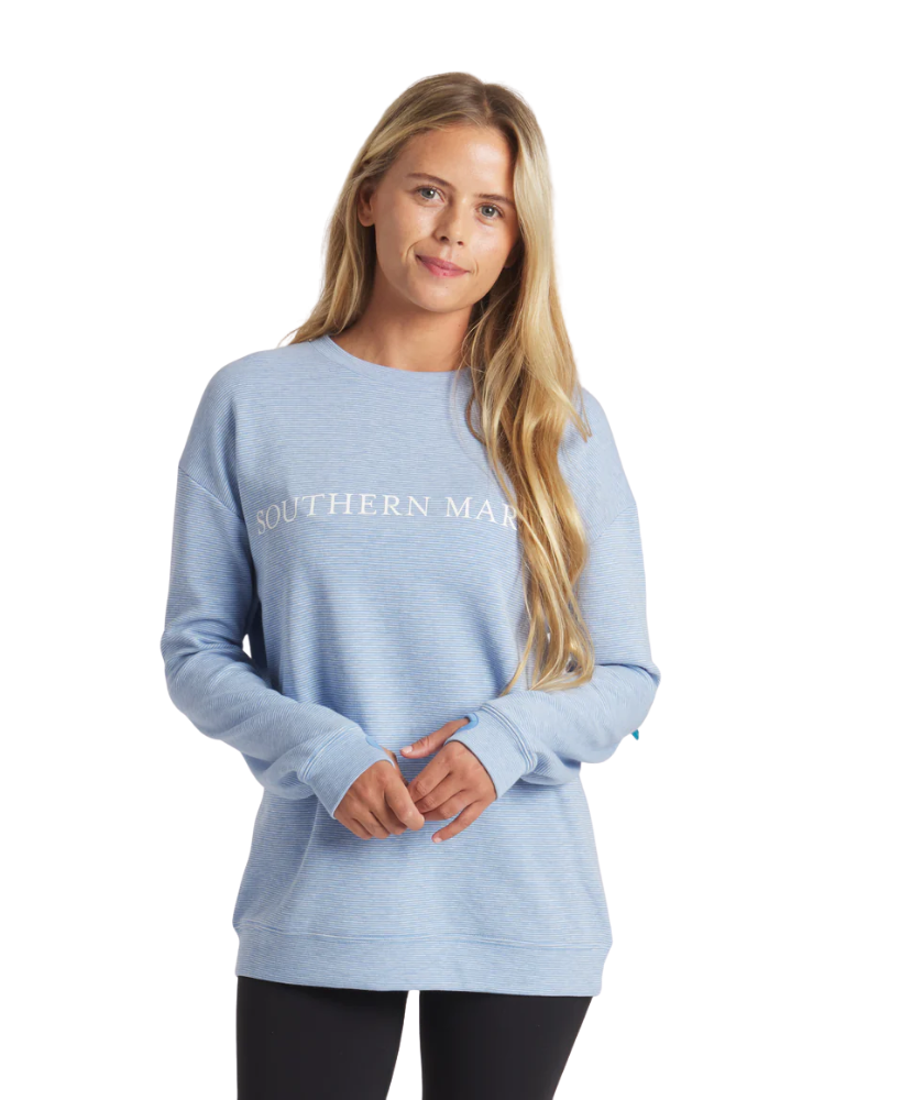 Woman wearing a light blue sweatshirt with 'Southern Marsh' text on a white background
