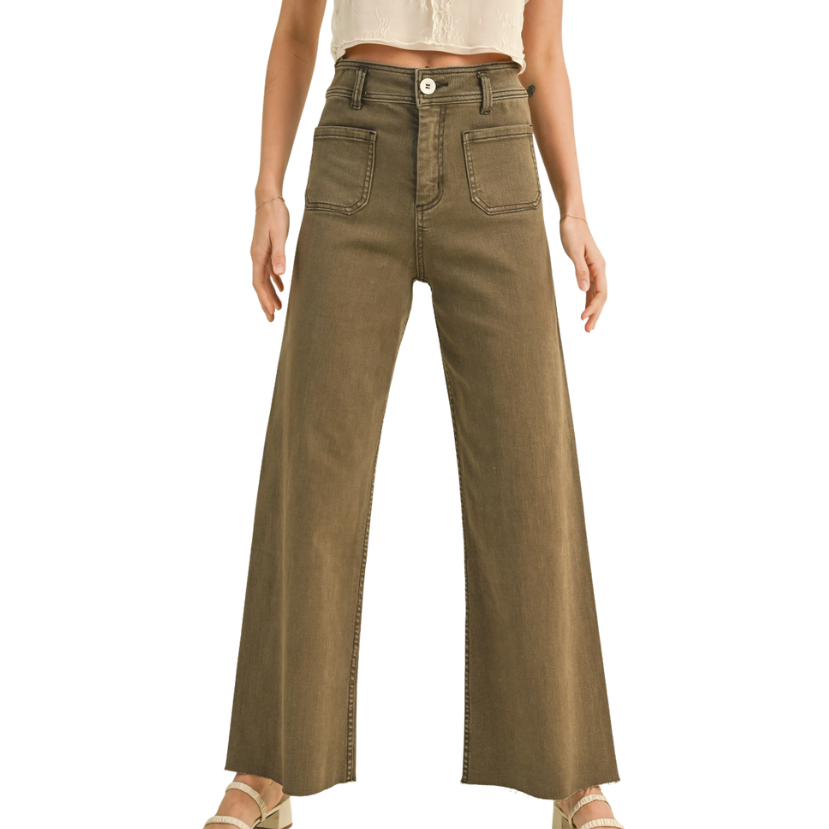 Person wearing high-waisted brown pants on a white background