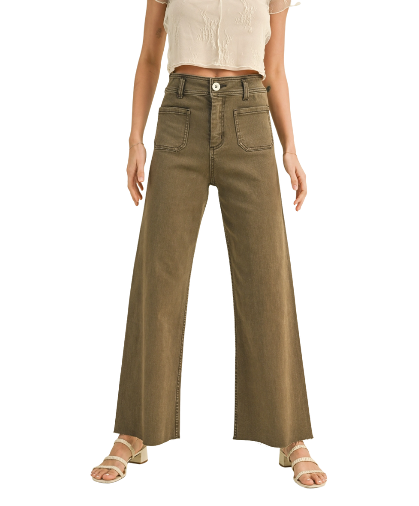 Person wearing high-waisted brown pants on a white background