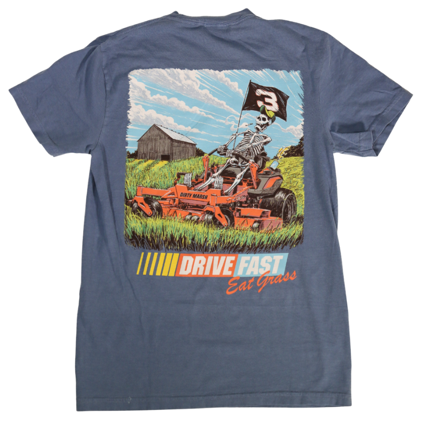 Blue t-shirt with a graphic of a skeleton driving a lawn mower and text 'Drive Fast Eat Grass' on a white background.