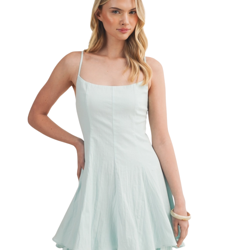 Woman wearing a light blue dress on a white background