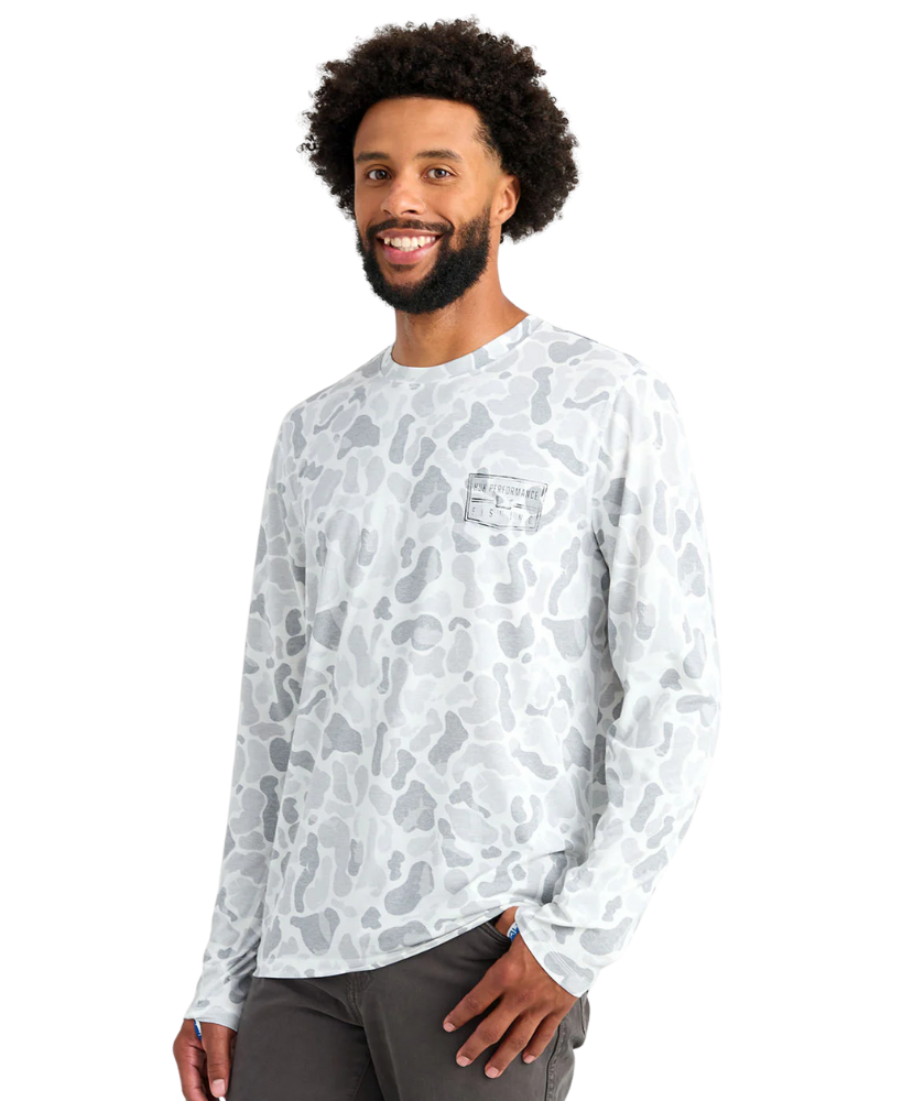 Man wearing a long-sleeve white camouflage shirt on a white background