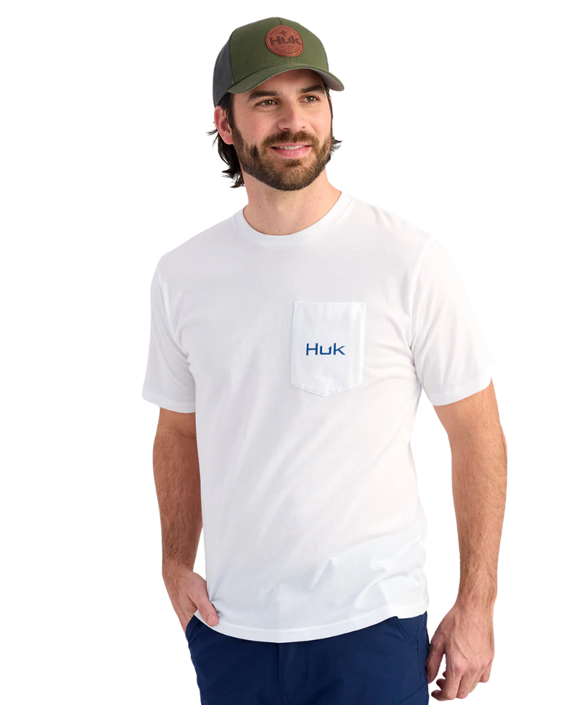 Man wearing a white Huk shirt and green cap on a white background