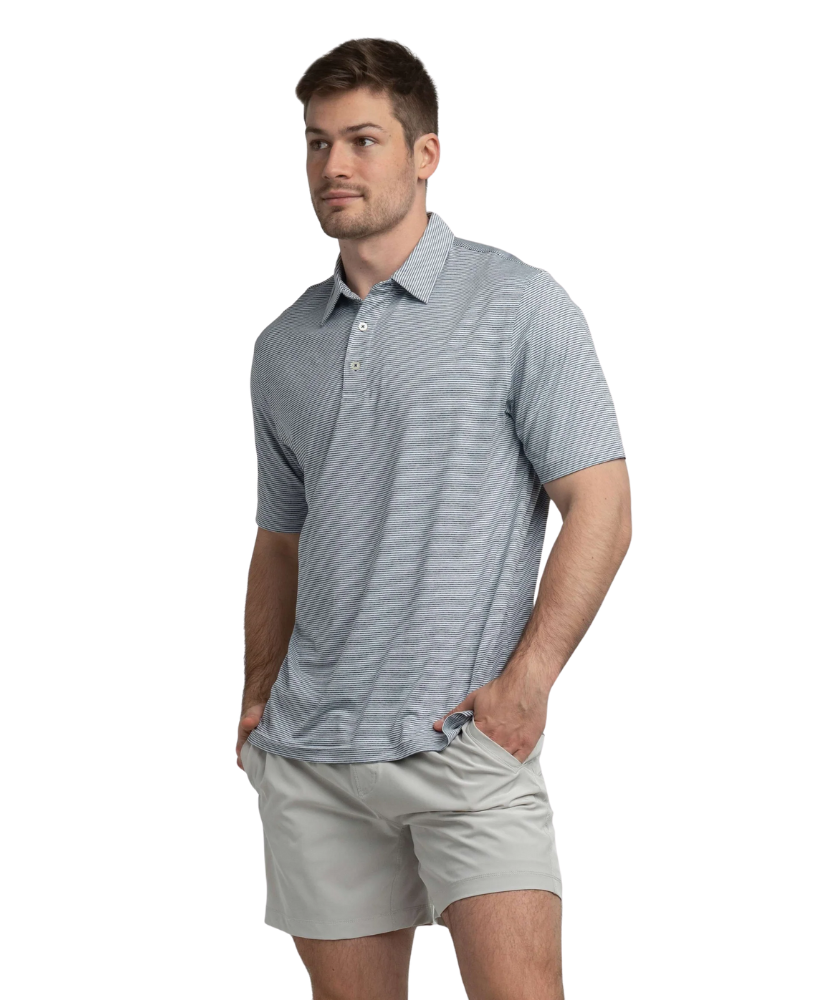 Man wearing a gray striped polo shirt and light gray shorts on a white background