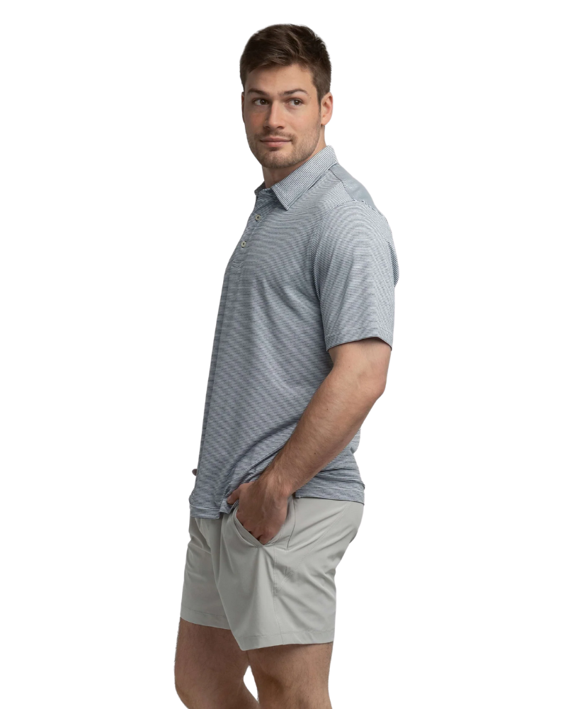 Man wearing a gray striped polo shirt and beige shorts on a white background