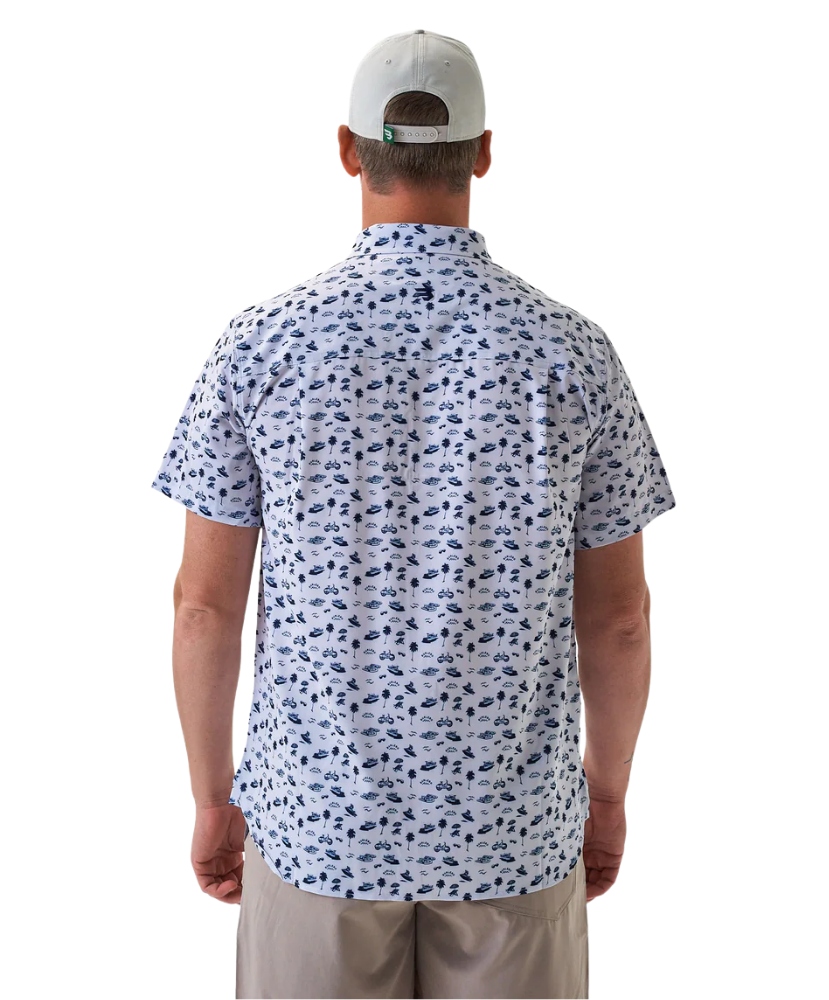 Man wearing a white short-sleeve button down shirt with a blue coastal pattern on a white background