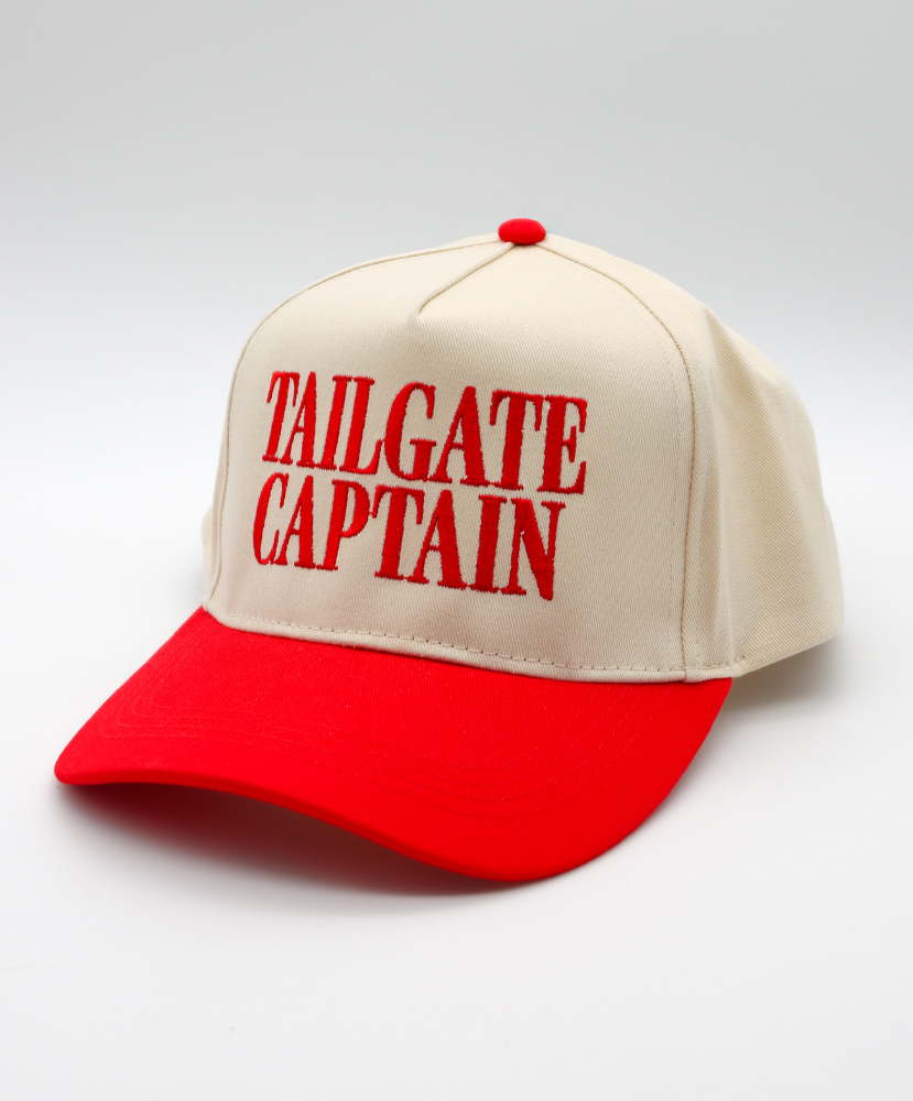Beige and red cap with 'TAILGATE CAPTAIN' text on a light gray background