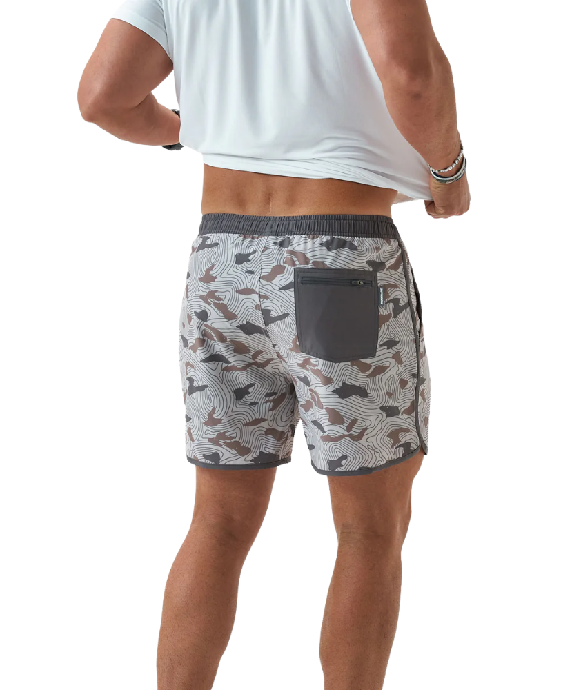 Person wearing camouflage swim shorts on a white background