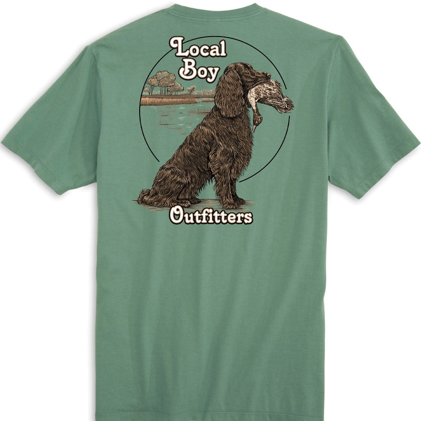 A green colored t-shirt with a graphic of a dog and the text 'Local Boy Outfitters' on the back.