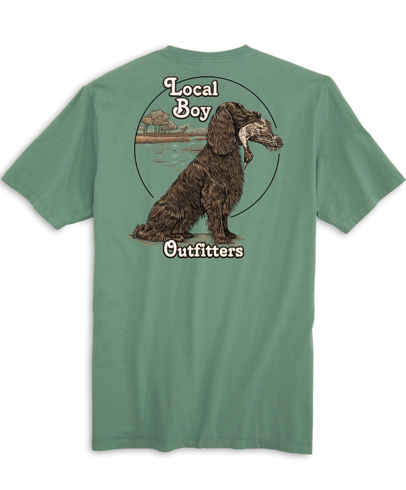 A green colored t-shirt with a graphic of a dog and the text 'Local Boy Outfitters' on the back.