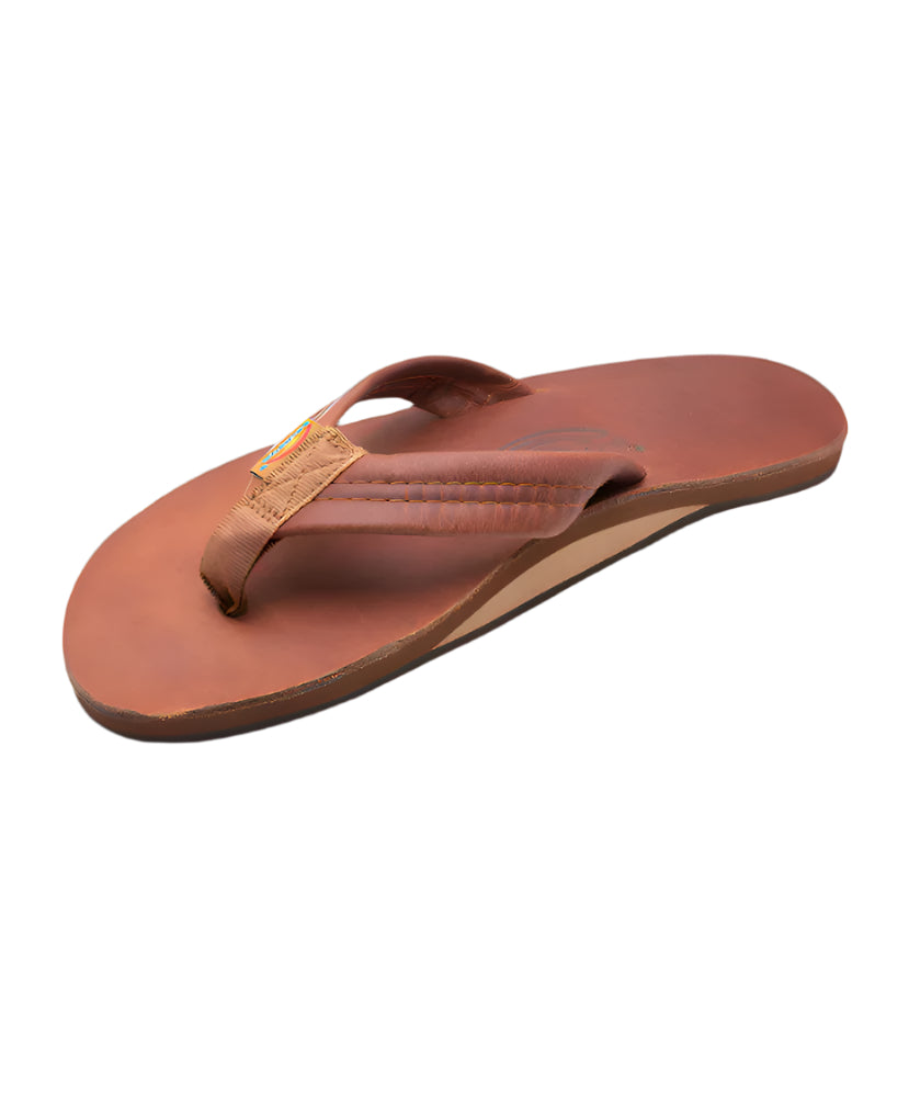 A single brown leather sandal with a simple strap design and a flat sole.