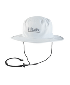 White fishing boonie hat with a strap on a white background, featuring the Huk brand.