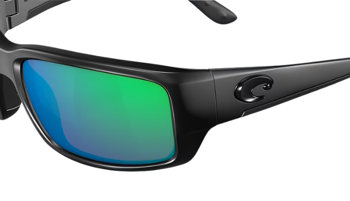 Black Costa wraparound Sunglasses with green mirror lenses on a white background