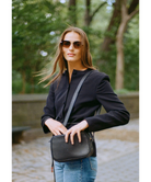 Woman wearing KREWE sunglasses and a BLACK TOP 