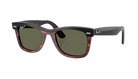 Sunglasses with tortoiseshell frame and green lenses on a white background