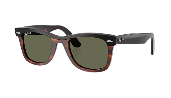 Sunglasses with tortoiseshell frame and green lenses on a white background