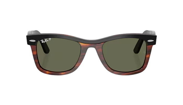 Sunglasses with tortoiseshell frame and green lenses on a white background
