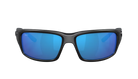 Black Costa wraparound sunglasses with blue lenses on a white background